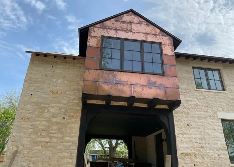 Copper metal panel facade on a stone building for Skylight Installation in Carol Stream