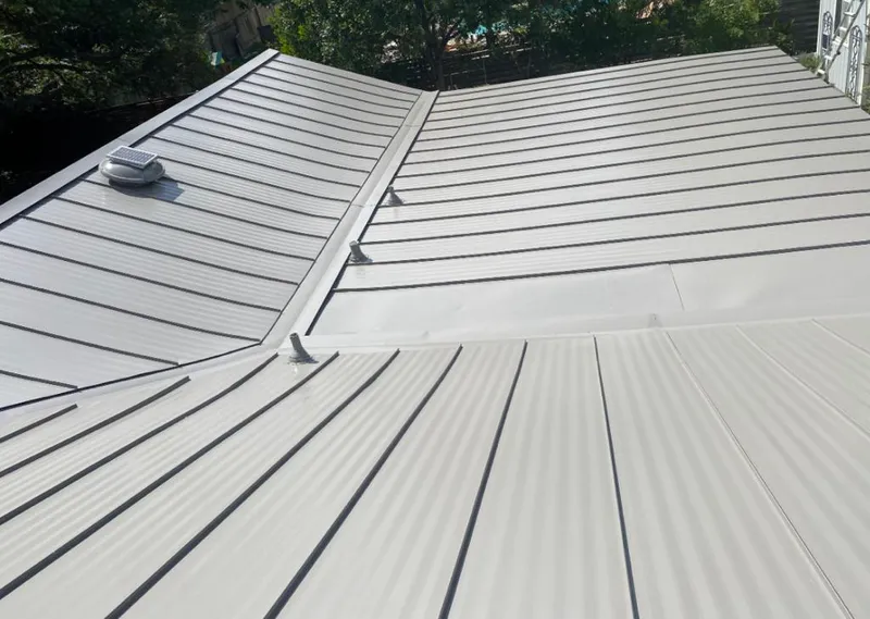 Solar attic fan installed on a metal roof for Roof Ventilation in Carol Stream